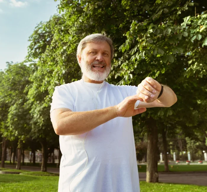 Active man checking his watch during a daily walk